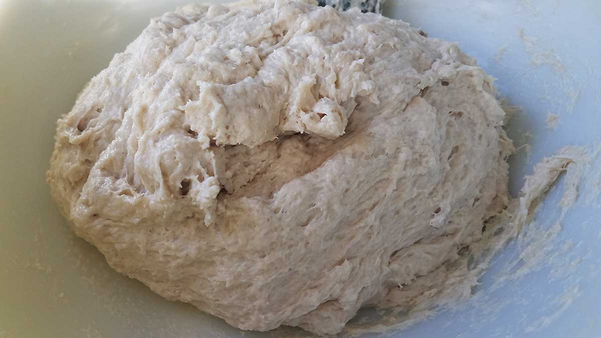 Mixing wet and dry ingredients for cuban bread dough.