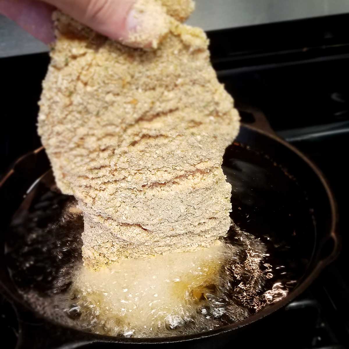 Schweinschnitzel frying in oil
