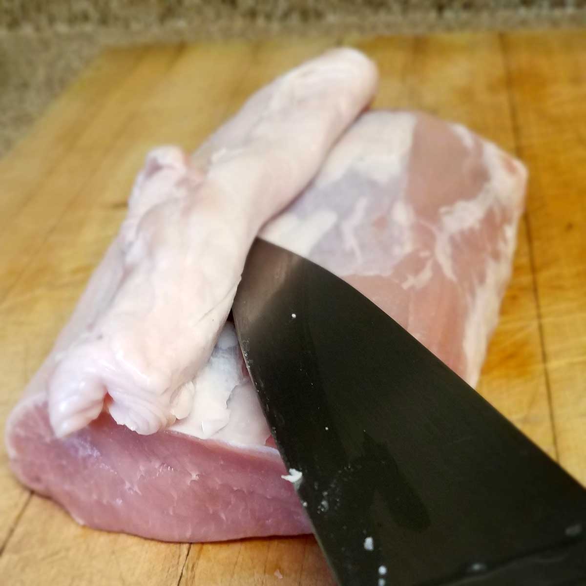 Trim fat from pork loin.